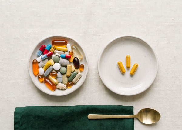 A collection of pills on one plate versus three capsules of ResilienZ-12 on the other